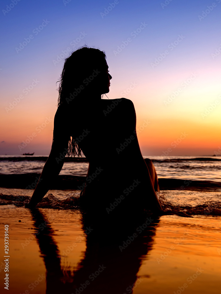Woman in swiming suit posing on the beach