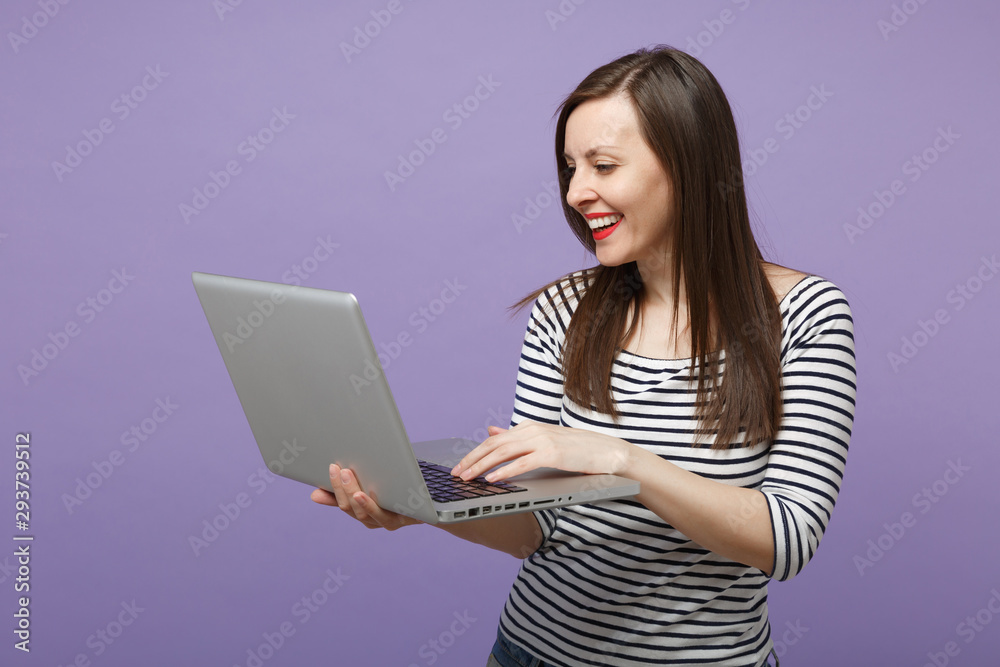 Young brunette woman girl in casual striped clothes posing isolated on violet purple background studio portrait. People sincere emotions lifestyle concept. Mock up copy space. Hold tablet pc computer. Young brunette woman girl in casual striped clothes posing isolated on violet purple background studio portrait. People sincere emotions lifestyle concept. Mock up copy space. Hold tablet pc computer.