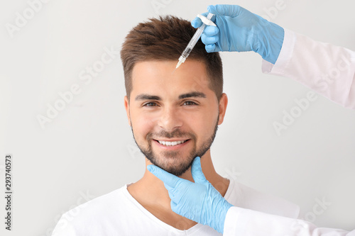 Handsome man receiving fill...