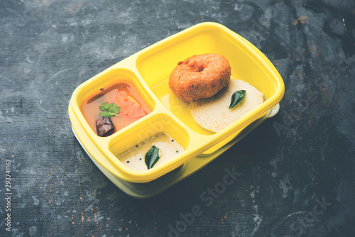 Idly / Idli with medu  Wada sambar in lunch box of tiffin photo