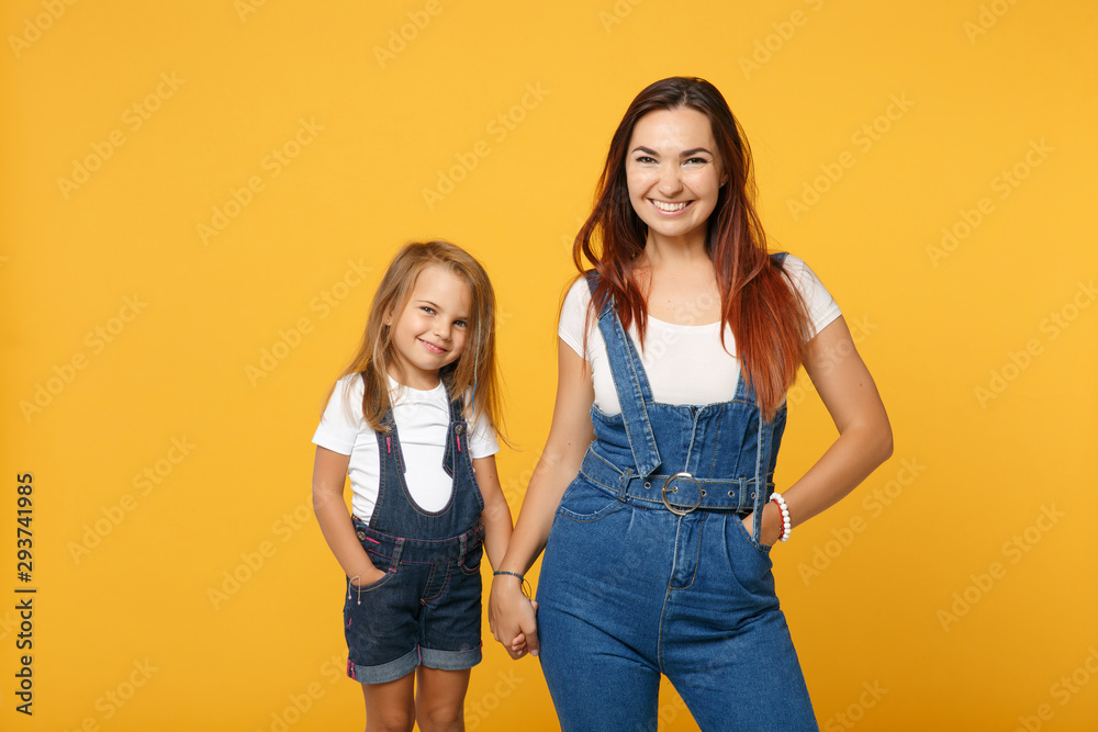 Woman in light clothes have fun with cute child baby girl 4-5 years old. Mommy little kid daughter isolated on yellow background studio portrait. Mother's Day love family parenthood childhood concept. Woman in light clothes have fun with cute child baby girl 4-5 years old. Mommy little kid daughter isolated on yellow background studio portrait. Mother's Day love family parenthood childhood concept.