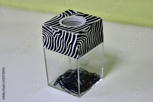 container with paper clips inside
