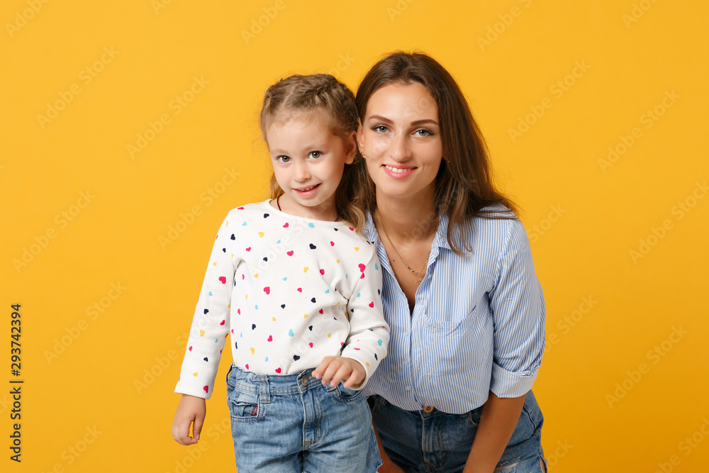 Woman in light clothes have fun with cute child baby girl 4-5 years old. Mommy little kid daughter isolated on yellow background studio portrait. Mother's Day love family parenthood childhood concept. Woman in light clothes have fun with cute child baby girl 4-5 years old. Mommy little kid daughter isolated on yellow background studio portrait. Mother's Day love family parenthood childhood concept.