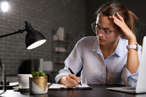 Tired businesswoman trying ...