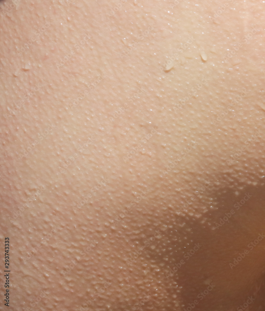 Fototapeta premium Human skin with drops of water as an abstract background