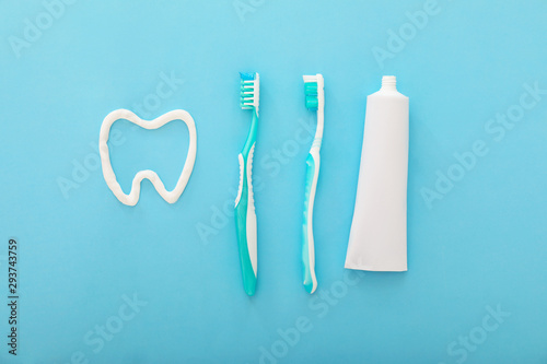 Tooth brushes and paste on color background