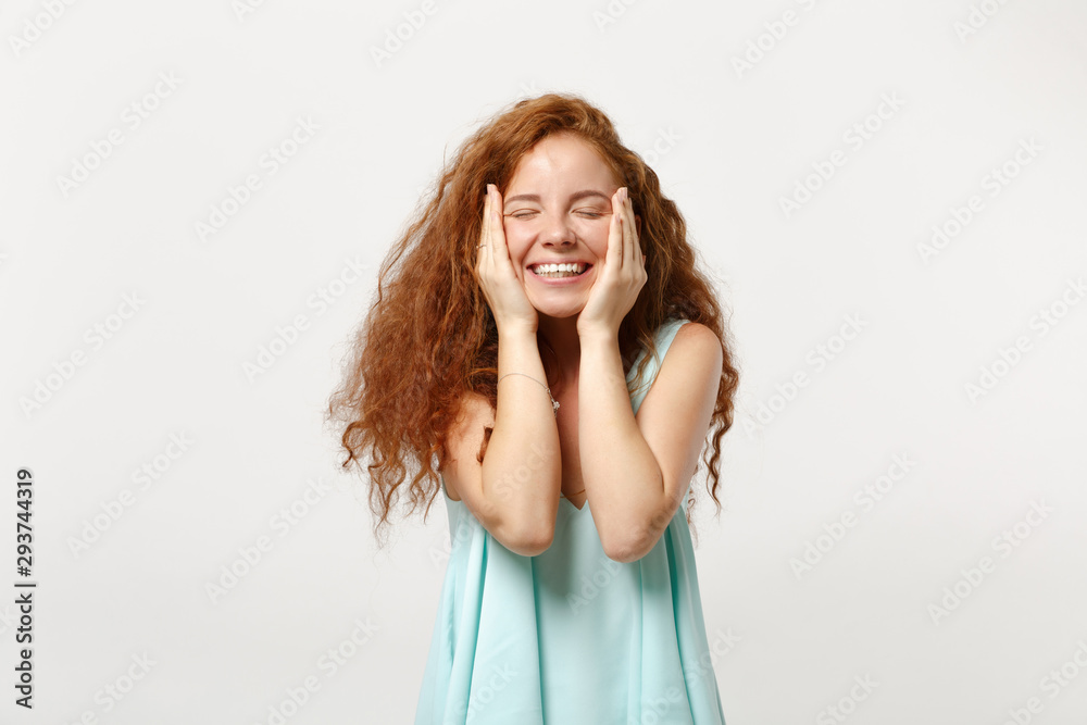 Young smiling redhead woman in casual light clothes posing isolated on white background. People sincere emotions lifestyle concept. Mock up copy space. Keeping eyes closed, putting hands on cheeks. Young smiling redhead woman in casual light clothes posing isolated on white background. People sincere emotions lifestyle concept. Mock up copy space. Keeping eyes closed, putting hands on cheeks.