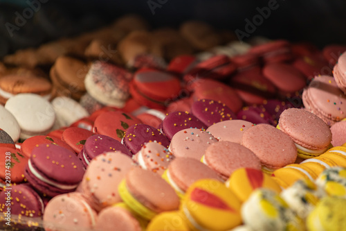 Colorful cakes macaron aka French macarons lie on the counter. Multi-colored macarons lie in rows. © bonilook