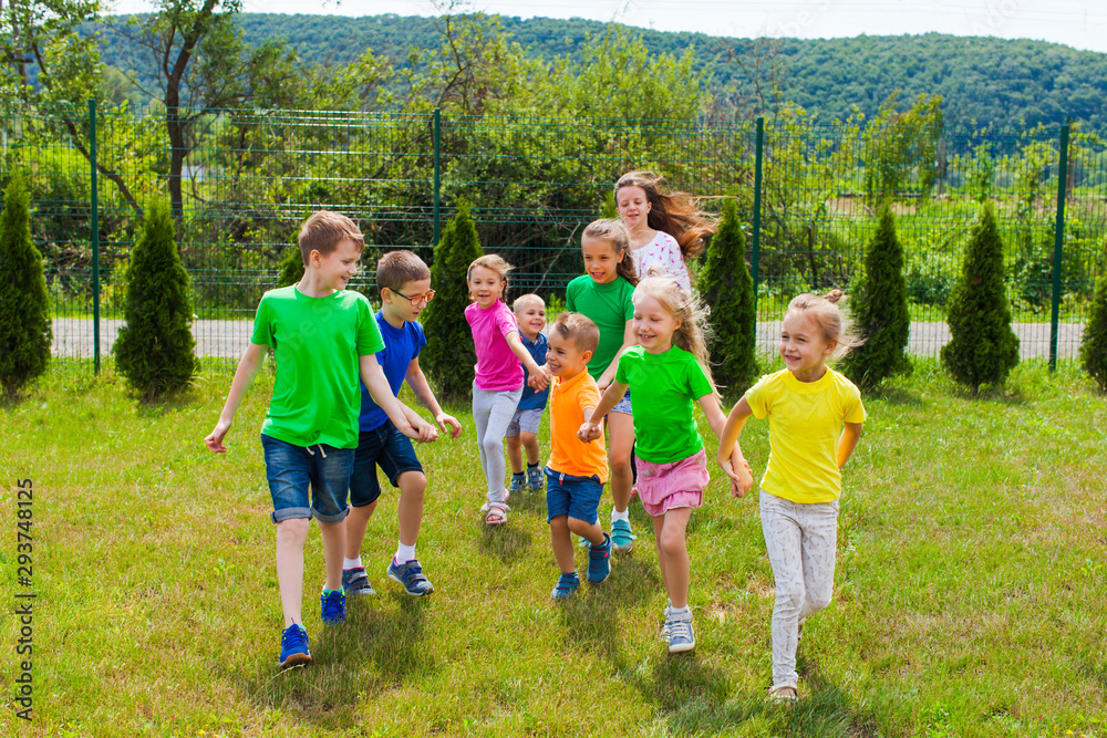 Obraz premium Kids with tutor have fun and go to the playground