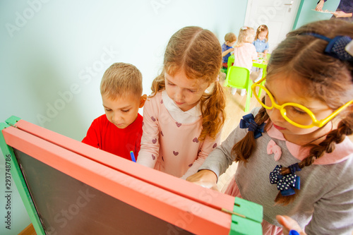 Children play with plastic magnetic digits on the board photo