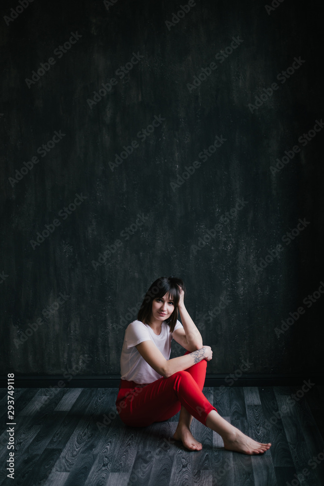 Portrait of young beautiful woman on black background.