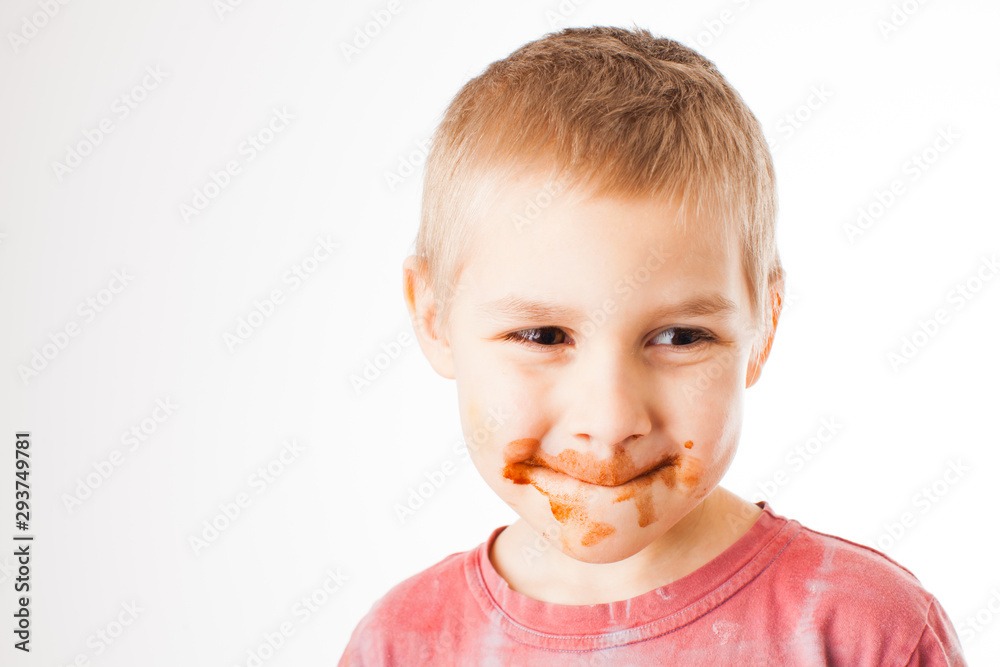 Portrait of fair-haired boy with chocolate on his face isolated on white Portrait of fair-haired boy with chocolate on his face isolated on white