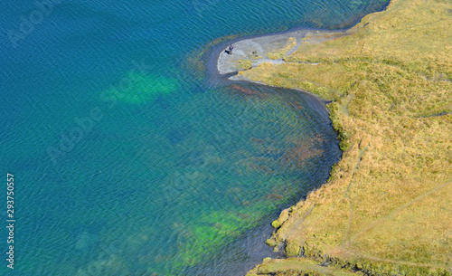 aerial view on a beautiful blue lake and its banks with yellow grass