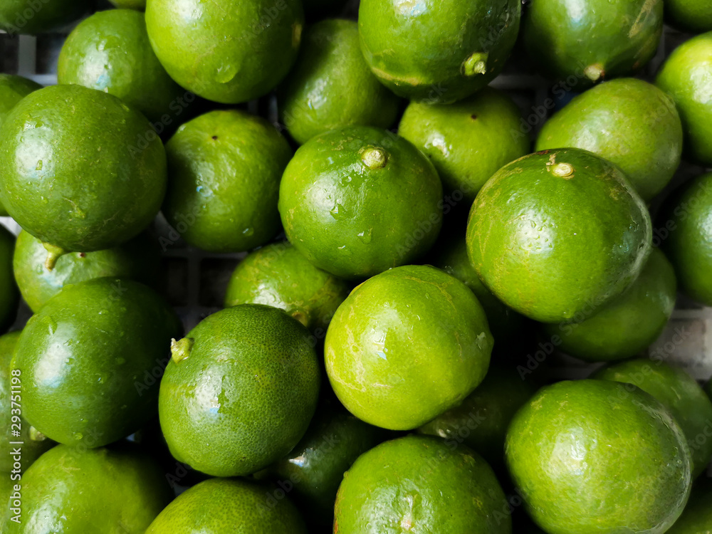 green lemon slices are placed in order to squeeze the juice. green lemon slices are placed in order to squeeze the juice.