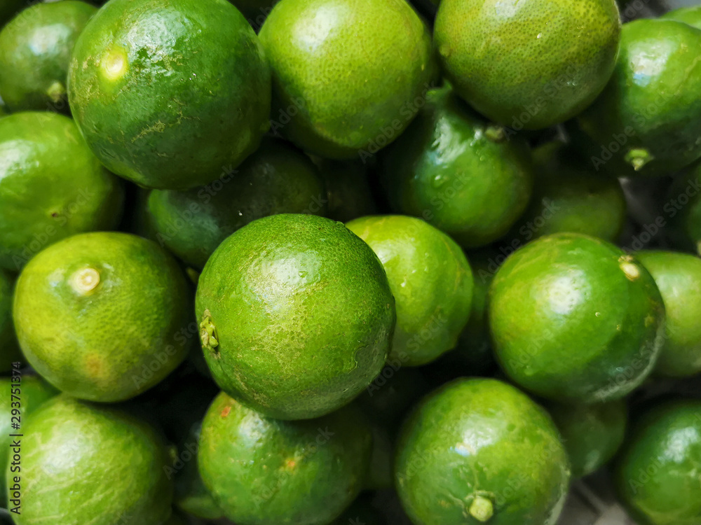 green lemon slices are placed in order to squeeze the juice. green lemon slices are placed in order to squeeze the juice.