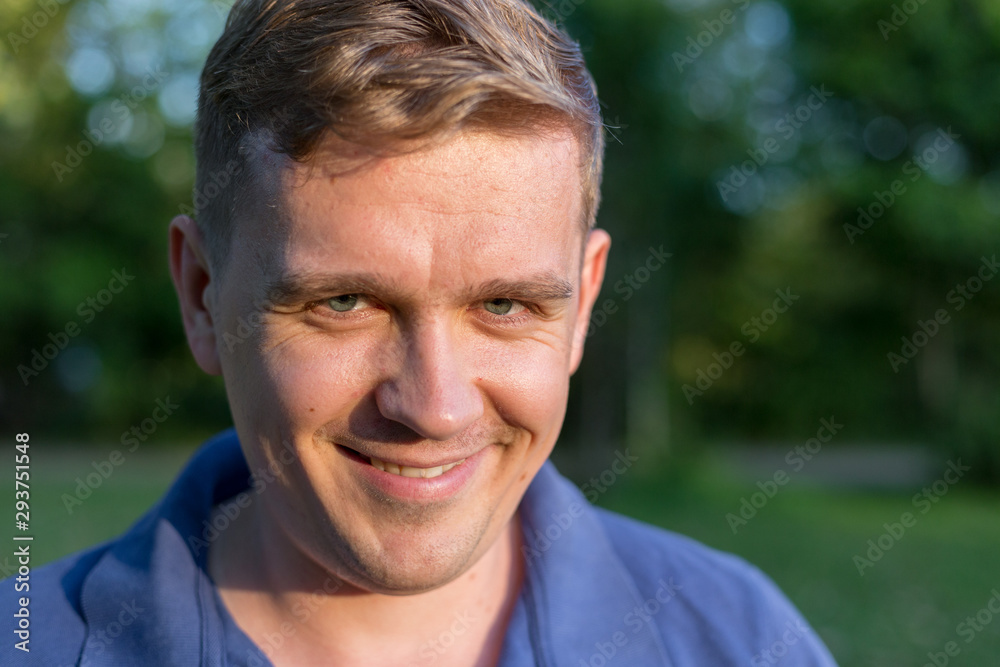 Portrait of a young man on nature background. Emotion facial expression. Smug smile, feelings and people reaction. Murderous psycho smile. crazy Killer lunatic man grinning. Portrait of a young man on nature background. Emotion facial expression. Smug smile, feelings and people reaction. Murderous psycho smile. crazy Killer lunatic man grinning.