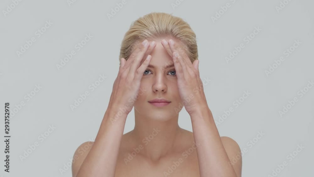 Studio portrait of young, beautiful and natural blond woman applying skin care cream. Face lifting, cosmetics and make-up. Studio portrait of young, beautiful and natural blond woman applying skin care cream. Face lifting, cosmetics and make-up.