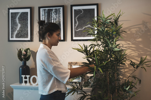 Woman taking care of home plants