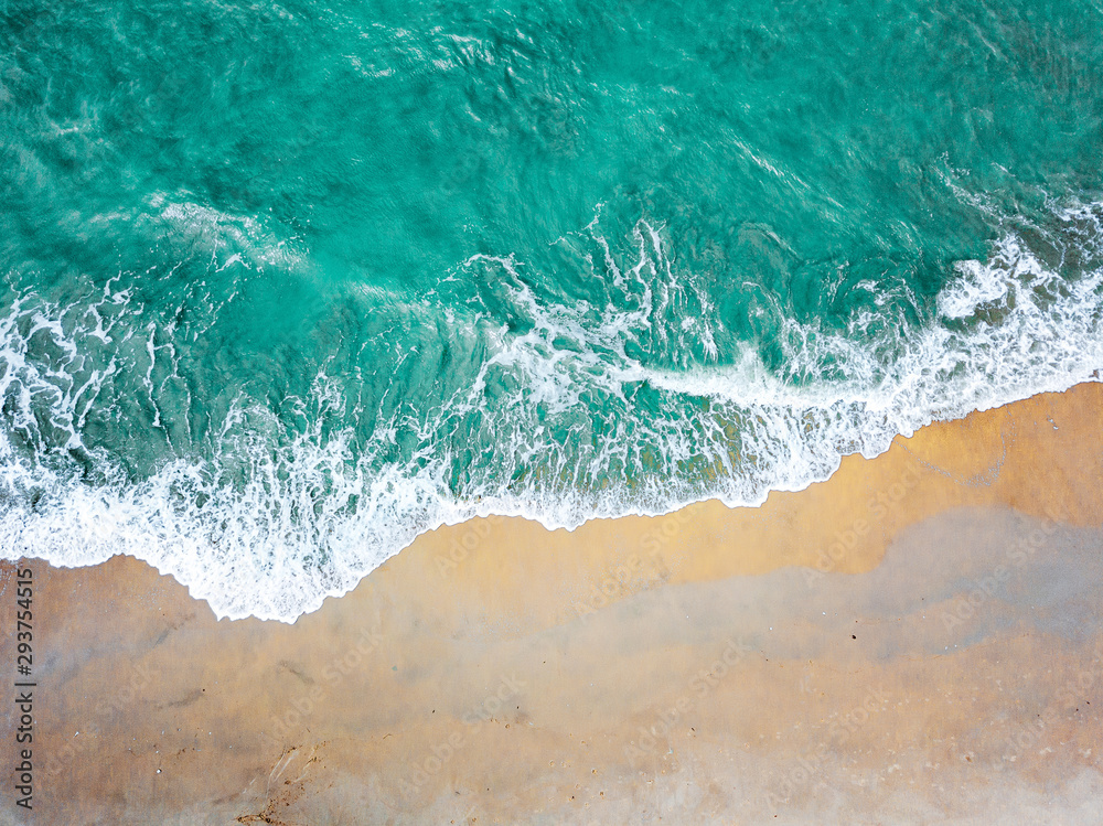 Top view of green turquoise sea water. Capture sea wave and beach in summer.