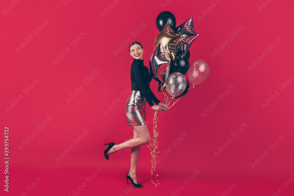 Full length body size view of nice attractive fascinating glamorous cheerful cheery girl holding in hands air balls having fun isolated over maroon burgundy marsala red pastel color background Full length body size view of nice attractive fascinating glamorous cheerful cheery girl holding in hands air balls having fun isolated over maroon burgundy marsala red pastel color background