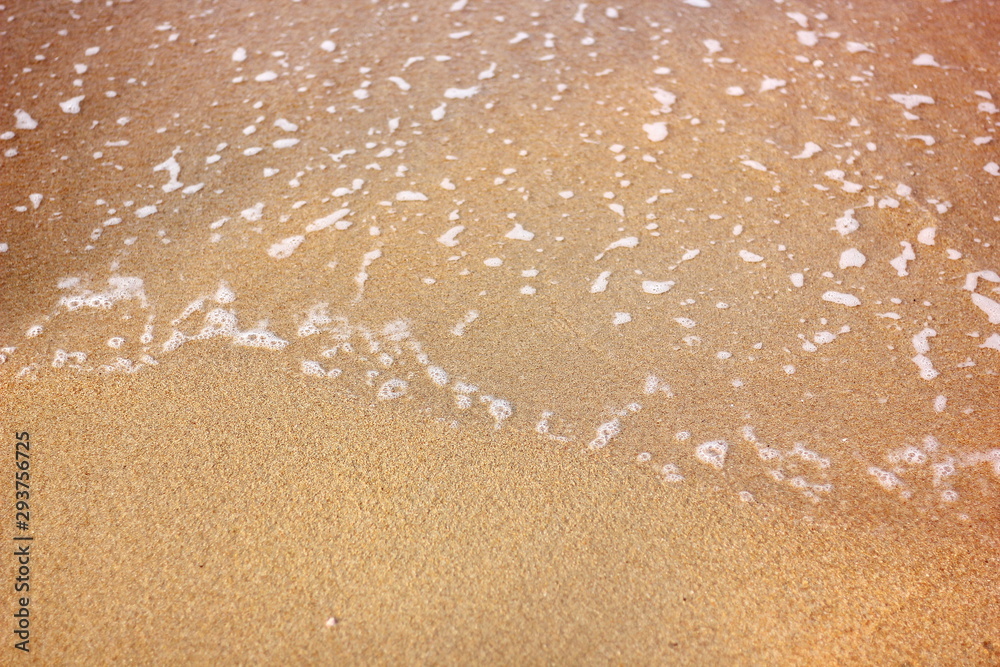 top view abstract sea wave on sand beach .white little sea wave go on coat,copy space