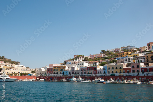 Ponza, Lazio / Italy - August 9 2019: port of the island of Ponza in the summer. The typical colored houses of the island of Ponza. Landscape of the harbor of island of Ponza. © tigrom
