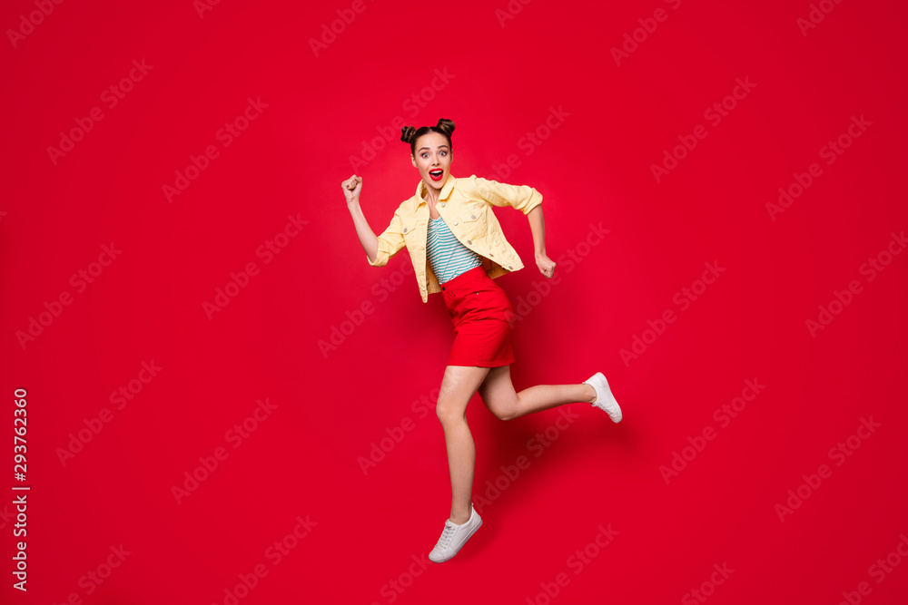 Full length photo of pretty jumping lady running fastly shopping wear casual outfit isolated red background Full length photo of pretty jumping lady running fastly shopping wear casual outfit isolated red background