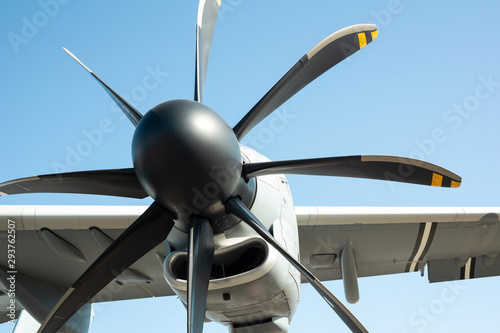 Aircraft propeller - detail of miliary aircraft and airplane. Clear blue sky in the background 