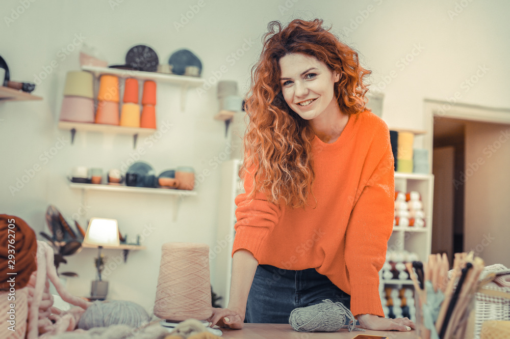 Positive delighted woman leaning on her workplace Positive delighted woman leaning on her workplace