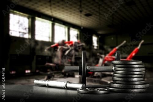 Fototapeta Naklejka Na Ścianę i Meble -  Gym interior and dumbbells on black desk with free space for your decoration. 