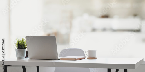Comfortable workplace with laptop computer, coffee cup and office supplies photo