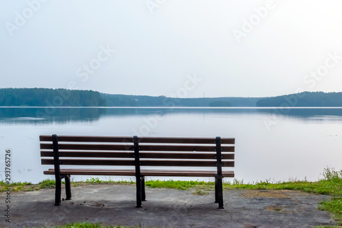 empty bench on the lake, summer morning