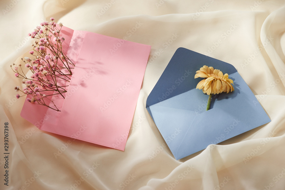 Pink and Blue envelope with a spring flower arrangement. Flat lay, top view Pink and Blue envelope with a spring flower arrangement. Flat lay, top view