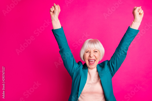 Portrait of her she nice attractive cheerful cheery overjoyed gray-haired lady wearing blue green jacket rejoicing rising hands up isolated on bright vivid shine vibrant pink fuchsia color background