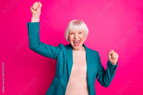 Portrait of her she nice attractive cheerful cheery gray-haired lady wearing blue green jacket great news rejoicing having fun isolated on bright vivid shine vibrant pink fuchsia color background photo