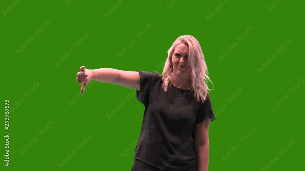 Female model on green screen giving thumbs down on the left side to refuse or disapprove something. Easy chroma keying by just one click is prepared. Female model on green screen giving thumbs down on the left side to refuse or disapprove something. Easy chroma keying by just one click is prepared.