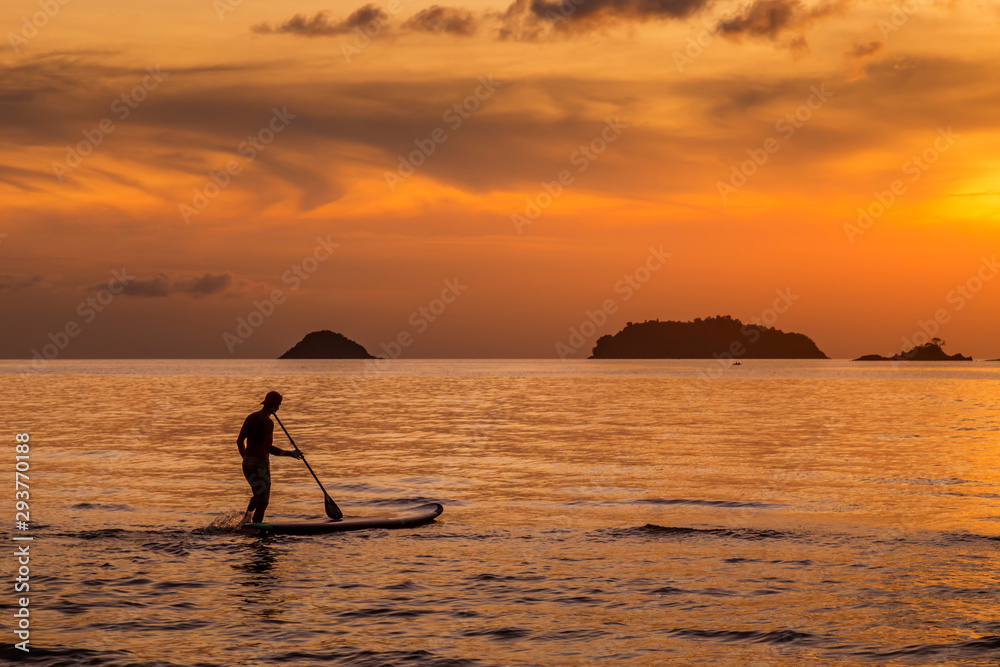 sup boarding at sunset in thailand