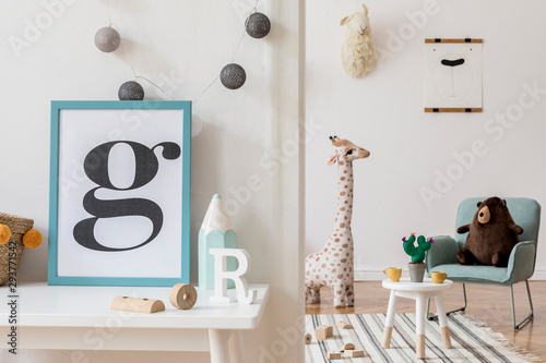 Modern and design scandinavian interior of kidroom with white desk, armachirs, mock up poster frame, natural basket, toys, teddy bear, plush toys and cute children's accessories. Stylish home decor. photo