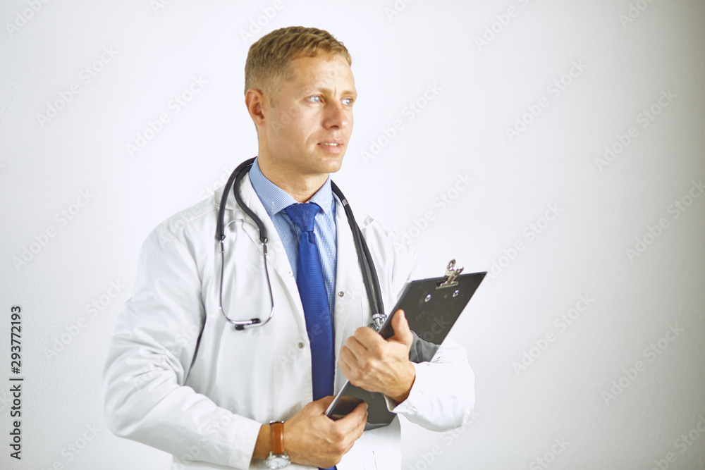 Young confident doctor in a white coat with a stethoscope Young confident doctor in a white coat with a stethoscope