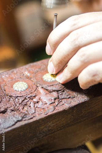 An artisan working with his hands in typical jewellery as they used to do many centuries ago
