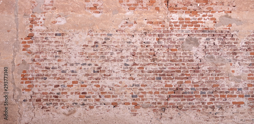Textured orange wall background plastered over bricks