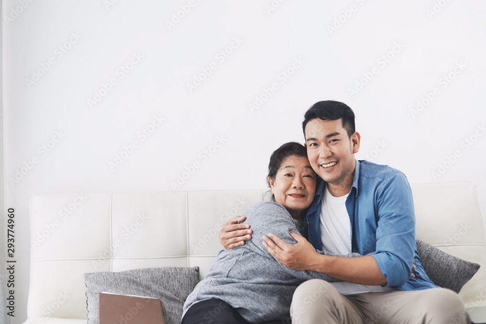 happy couple sitting on sofa at home