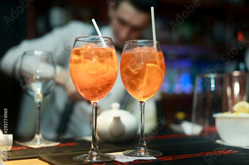 Two cocktails with orange on bar in restaurant
