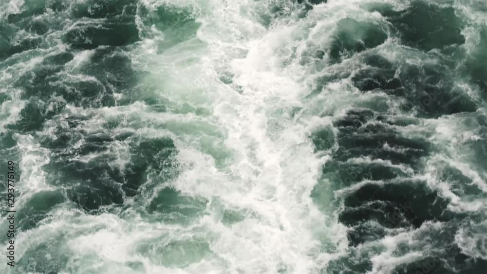 Huge boat wake in deep, clear saltwater violently churning with white froth . Locked down shot in real time speed. Huge boat wake in deep, clear saltwater violently churning with white froth . Locked down shot in real time speed.