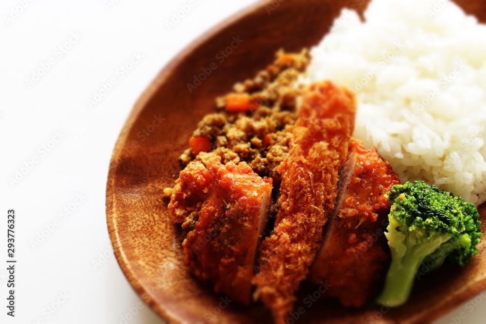 Japanese dried curry and cutlet on wooden plate Japanese dried curry and cutlet on wooden plate