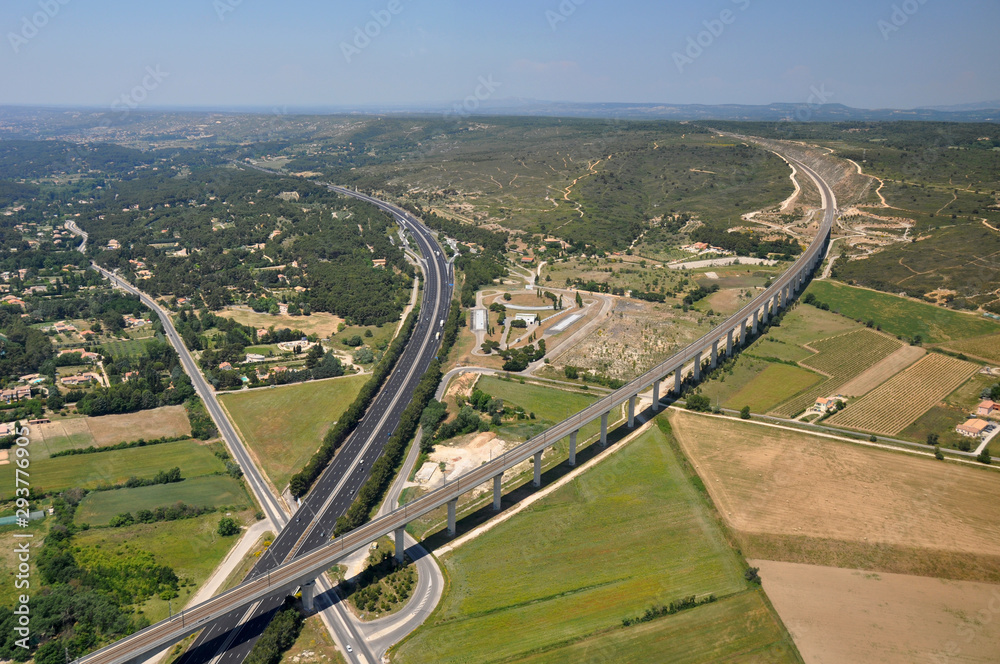 Aerial view of the high speed train TGV and A8 highway crossing in the south of France near Aix en Provence