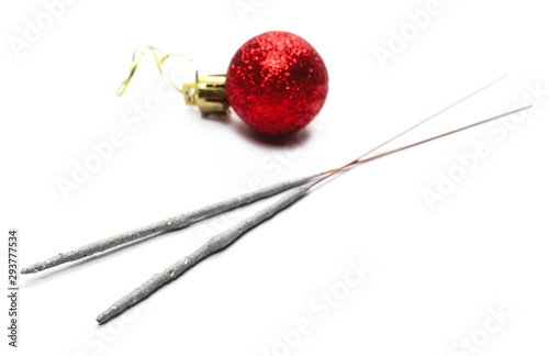 Red Christmas bauble ornament with glittering string for hanging and sparklers, isolated on white background