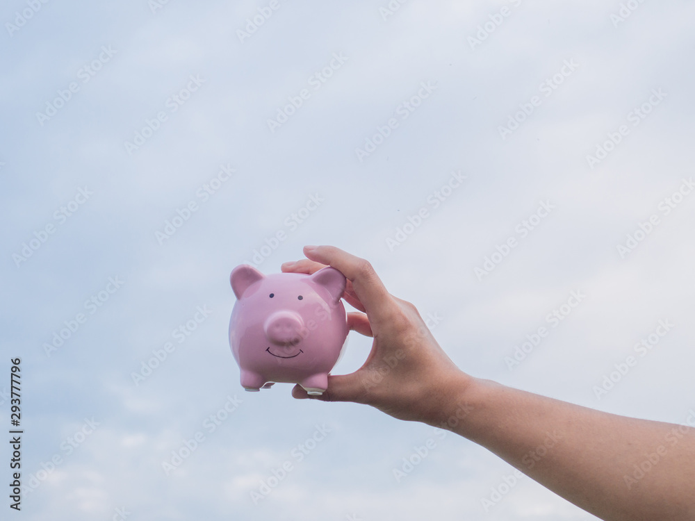 pink piggy bank on the blue sky with cloud background, Saving money for future plan and retirement fund concept