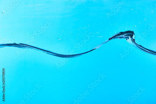 wavy fresh water on blue background with drops
