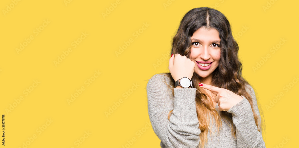 Young beautiful woman wearing winter dress In hurry pointing to watch time, impatience, upset and angry for deadline delay